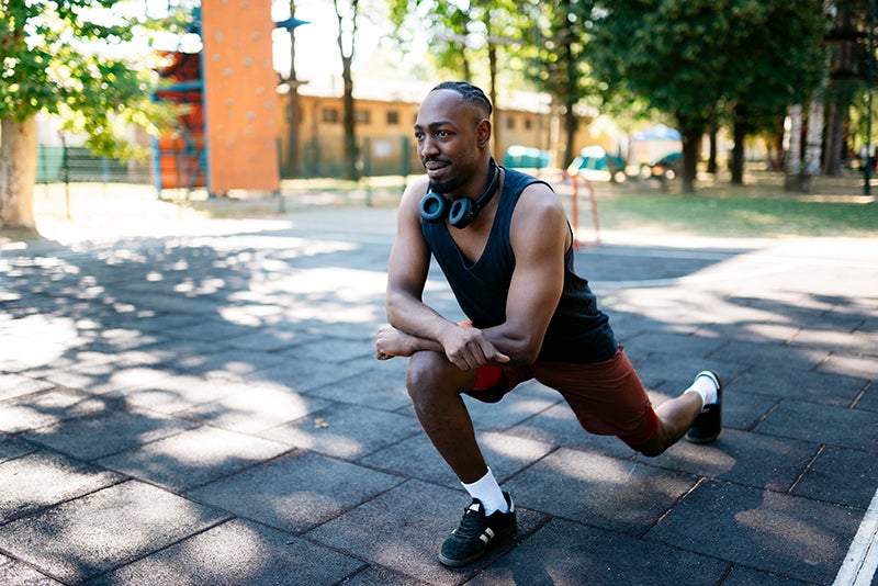 man stretching his knee and hip